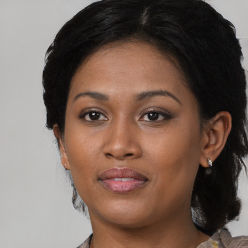 Joyful black young-adult female with medium  black hair and brown eyes