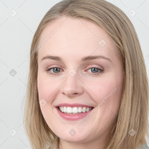 Joyful white young-adult female with long  brown hair and blue eyes