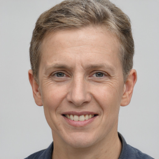 Joyful white adult male with short  brown hair and grey eyes