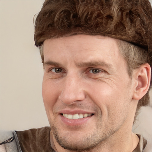 Joyful white adult male with short  brown hair and grey eyes