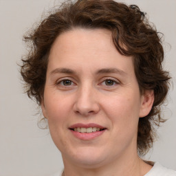 Joyful white young-adult female with medium  brown hair and green eyes