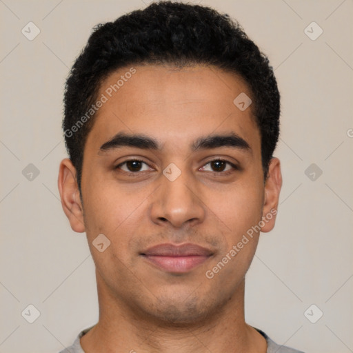 Joyful latino young-adult male with short  brown hair and brown eyes