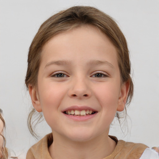 Joyful white child female with medium  brown hair and brown eyes