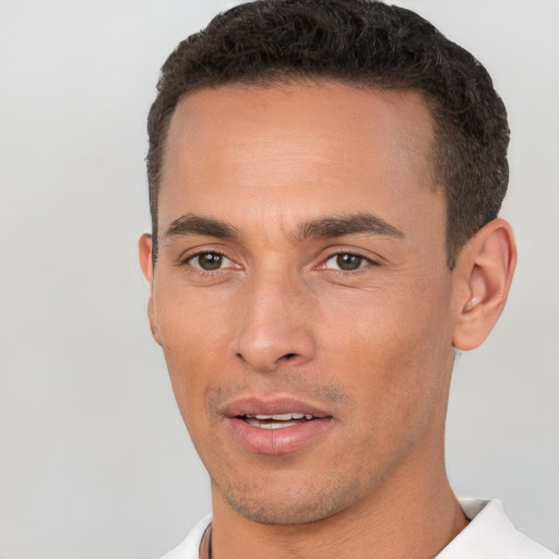 Joyful white young-adult male with short  brown hair and brown eyes