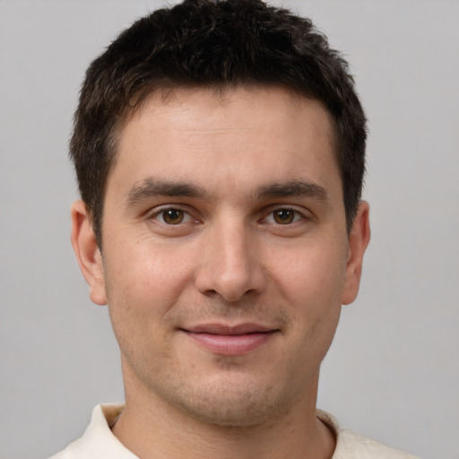 Joyful white young-adult male with short  brown hair and brown eyes