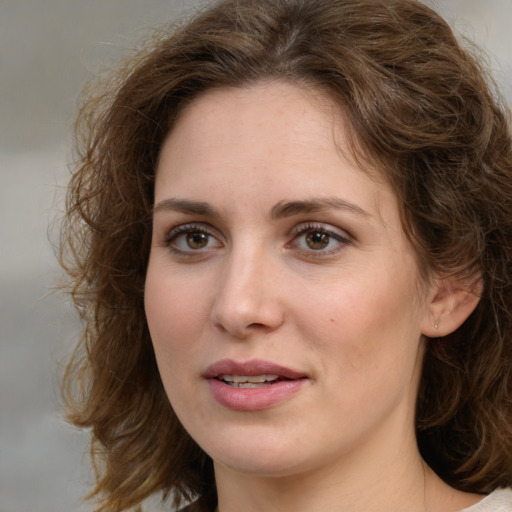 Joyful white young-adult female with medium  brown hair and green eyes