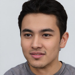 Joyful asian young-adult male with short  black hair and brown eyes