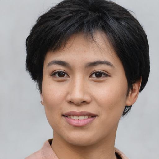 Joyful asian young-adult female with short  brown hair and brown eyes