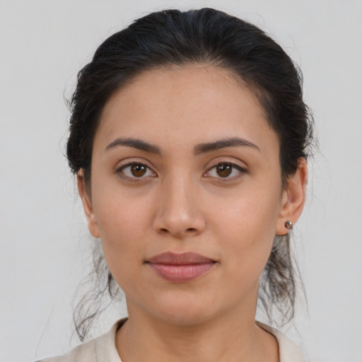 Joyful latino young-adult female with medium  brown hair and brown eyes