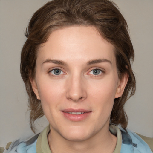 Joyful white young-adult female with medium  brown hair and green eyes