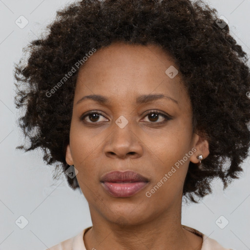 Joyful black adult female with short  brown hair and brown eyes