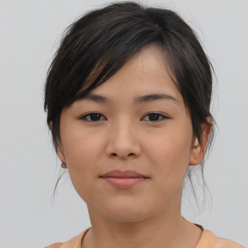 Joyful asian young-adult female with medium  brown hair and brown eyes