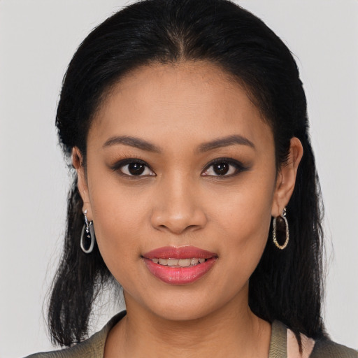 Joyful latino young-adult female with long  black hair and brown eyes