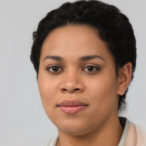 Joyful black young-adult female with short  black hair and brown eyes