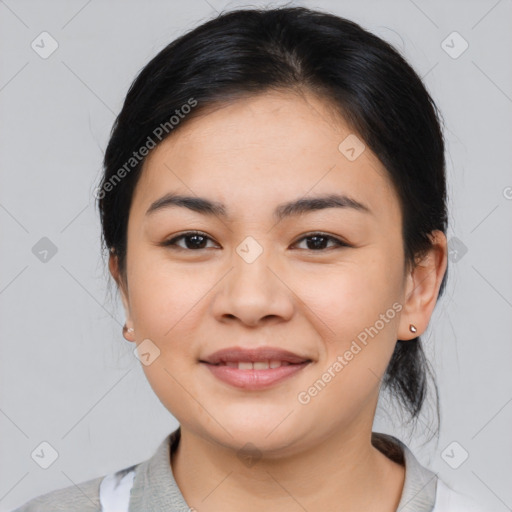 Joyful latino young-adult female with medium  brown hair and brown eyes