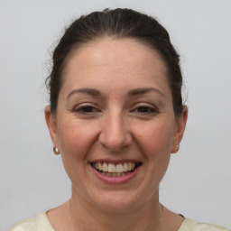 Joyful white adult female with short  brown hair and grey eyes