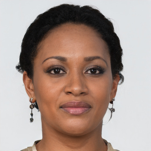Joyful black young-adult female with short  brown hair and brown eyes