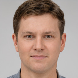 Joyful white adult male with short  brown hair and grey eyes