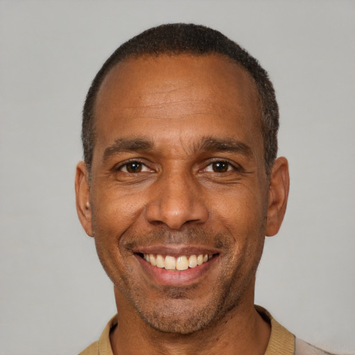 Joyful latino adult male with short  brown hair and brown eyes