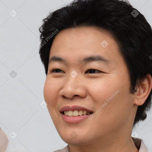 Joyful asian young-adult male with short  black hair and brown eyes