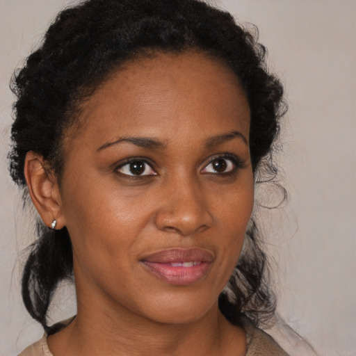 Joyful black adult female with medium  brown hair and brown eyes
