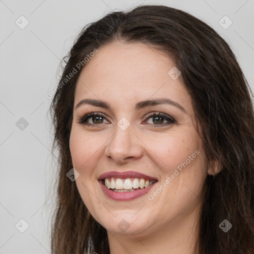 Joyful white adult female with long  brown hair and brown eyes