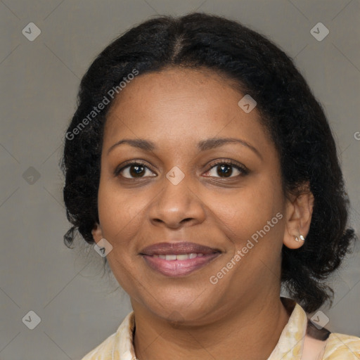 Joyful black adult female with medium  brown hair and brown eyes