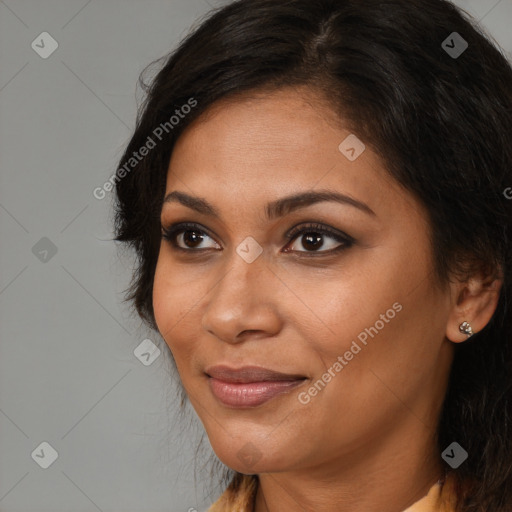 Joyful black young-adult female with long  brown hair and brown eyes