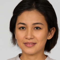 Joyful asian young-adult female with medium  brown hair and brown eyes