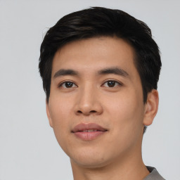 Joyful asian young-adult male with short  black hair and brown eyes