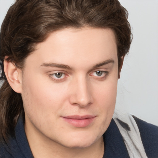 Joyful white young-adult male with medium  brown hair and grey eyes