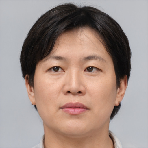 Neutral asian adult female with short  brown hair and brown eyes