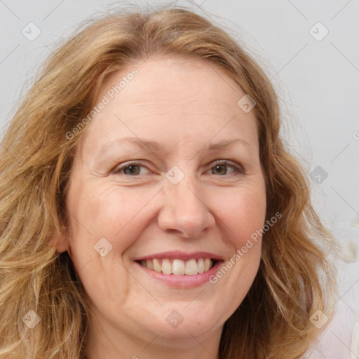 Joyful white adult female with medium  brown hair and blue eyes