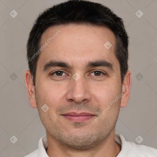 Joyful white adult male with short  black hair and brown eyes