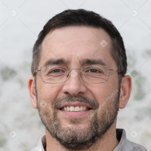 Joyful white adult male with short  black hair and brown eyes