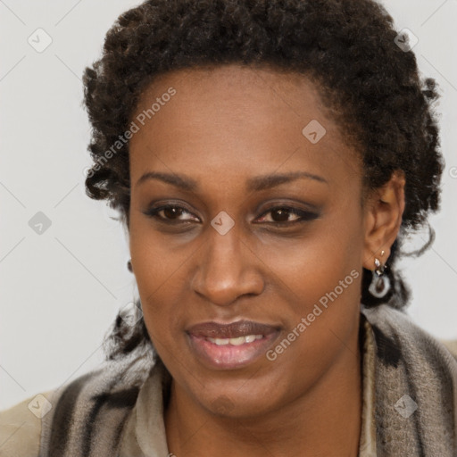 Joyful black adult female with short  brown hair and brown eyes