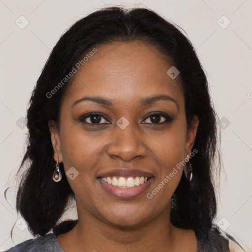 Joyful black young-adult female with long  brown hair and brown eyes