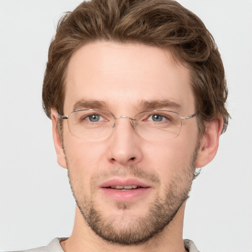 Joyful white adult male with short  brown hair and grey eyes