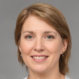 Joyful white adult female with medium  brown hair and grey eyes