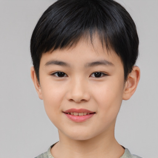 Joyful asian child male with short  brown hair and brown eyes