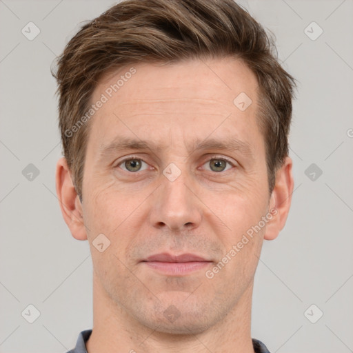 Joyful white adult male with short  brown hair and grey eyes