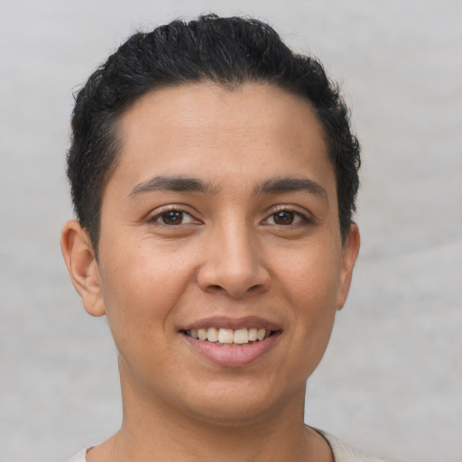 Joyful latino young-adult male with short  brown hair and brown eyes