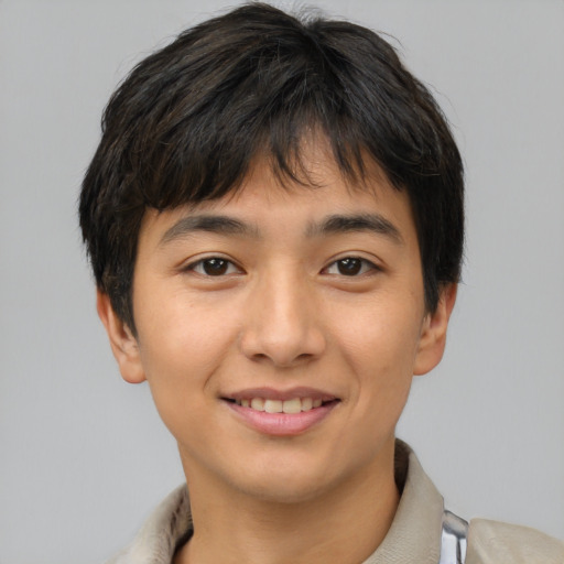 Joyful asian young-adult male with short  brown hair and brown eyes