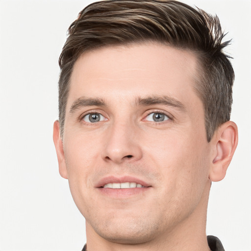 Joyful white young-adult male with short  brown hair and grey eyes