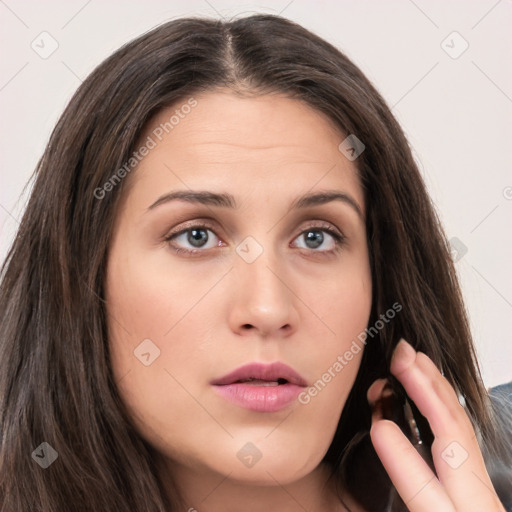 Neutral white young-adult female with long  brown hair and brown eyes