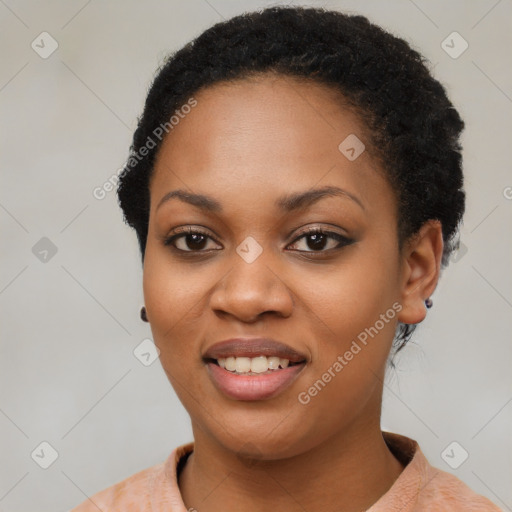 Joyful black young-adult female with short  black hair and brown eyes