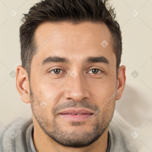 Joyful white young-adult male with short  brown hair and brown eyes