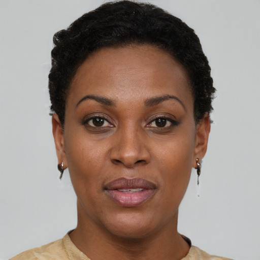 Joyful black young-adult female with short  brown hair and brown eyes
