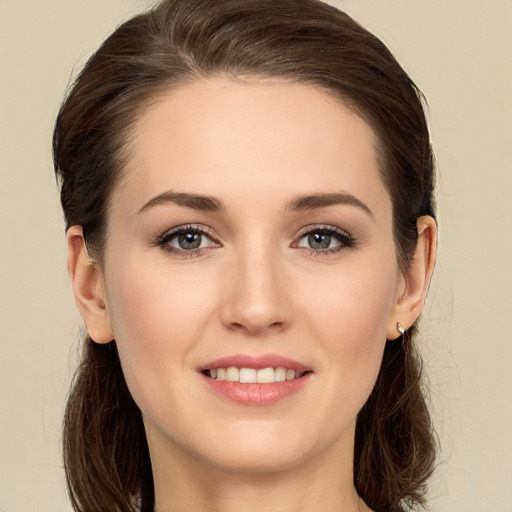 Joyful white young-adult female with long  brown hair and brown eyes