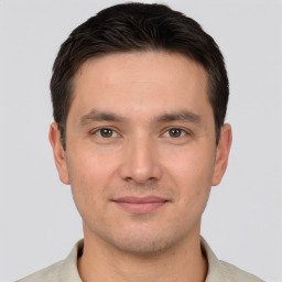 Joyful white young-adult male with short  brown hair and brown eyes